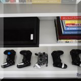 E04. PS4 game console and controllers. 